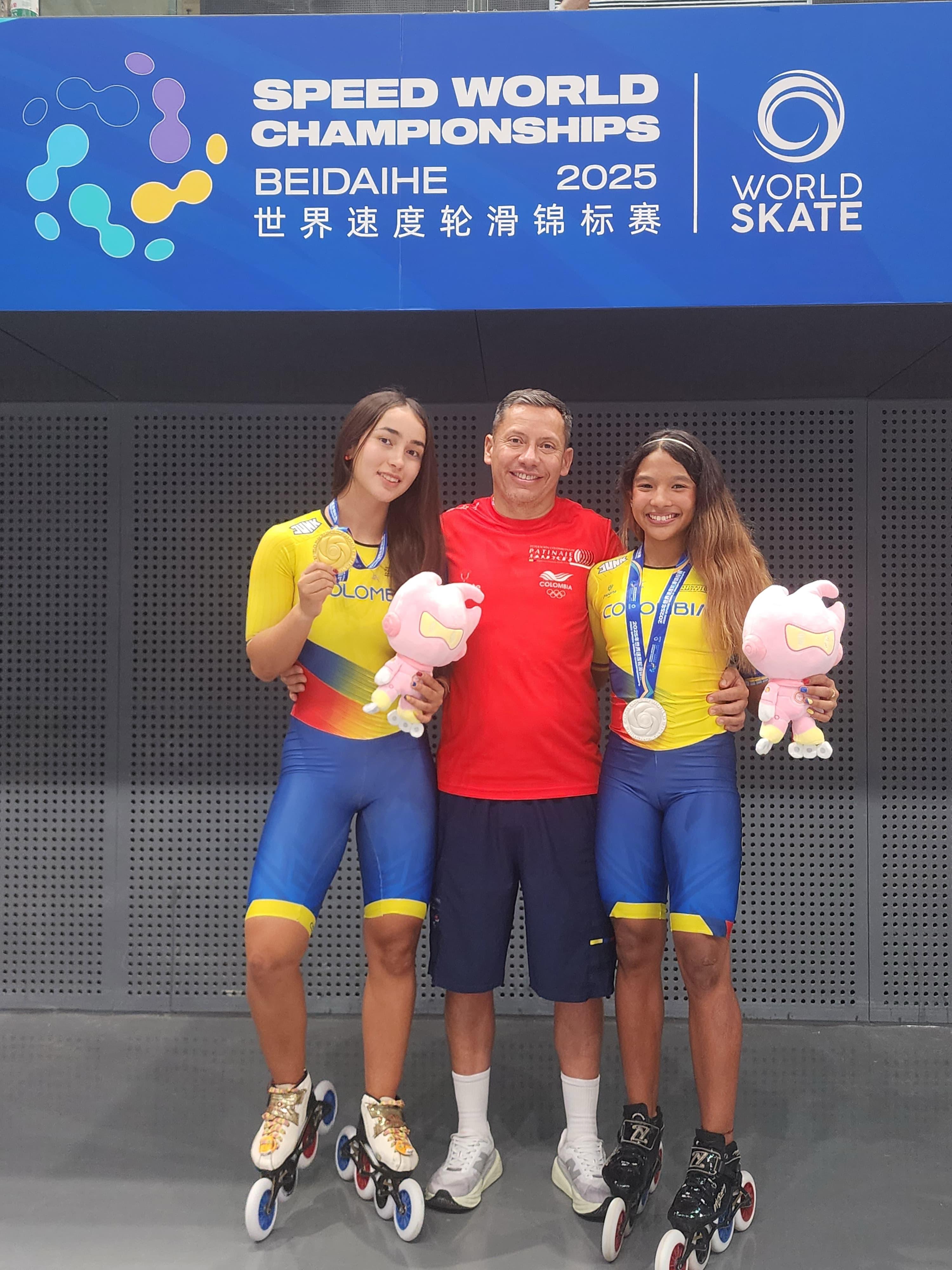 El entrenador de Bogotá, Anwar Cárdenas, con las campeonas mundiales Manuela Rodríguez (izq.) y Mariana Imitola (der.). Foto IDRD.