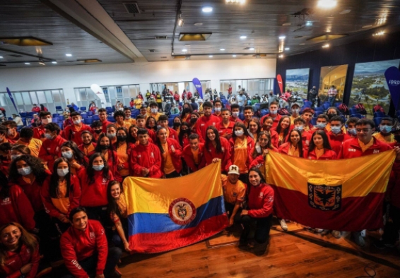 Deportistas del Equipo Bogotá sosteniendo la bandera de Colombia