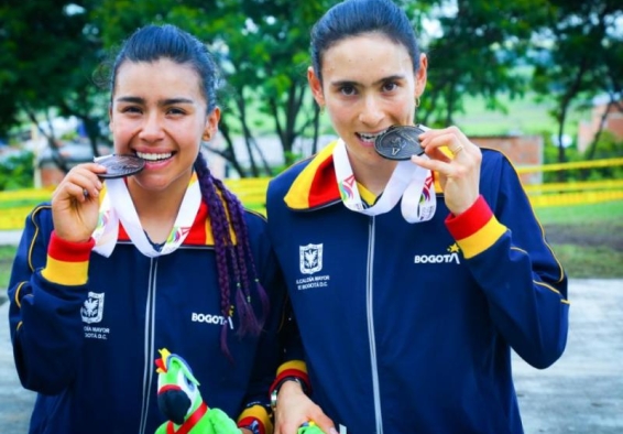 deportistas mordiendo medallas