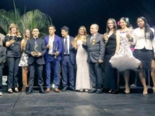 Deportistas sostienen trofeos en ceremonia